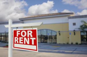 Vacant Retail Building with For Rent Real Estate Sign photo