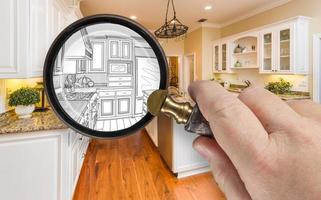 Hand Holding Magnifying Glass Revealing Custom Kitchen Design Drawing and Photo Combination