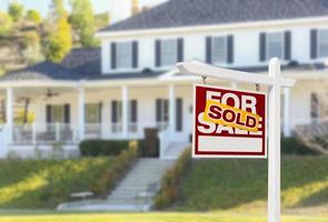 Sold Home For Sale Sign in Front of New House photo