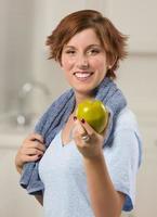 Pretty Red Haired Woman with Towel Holding Green Apple photo