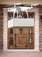 Unmanned Aircraft System UAV Quadcopter Drone Delivering Package At House photo