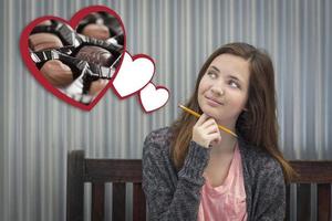 Daydreaming Girl Next To Floating Hearts with Chocolates photo