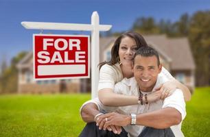 Hispanic Couple, New Home and For Sale Real Estate Sign photo