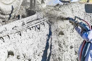 Pool Construction Worker Shooting Concrete, Shotcrete or Gunite Through Hose photo