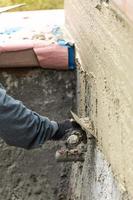 Tile Worker Applying Cement with Trowel at Pool Construction Site photo