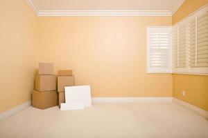 Moving Boxes and Blank Signs on Floor in Empty Room photo