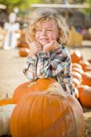 Little Boy Standing in a Rustic Ranch Setting at the Pumpkin Patch. photo