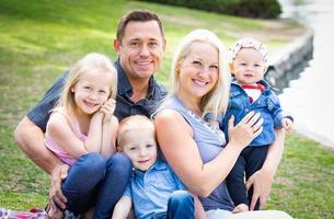 Happy Young Caucasian Family Portrait In The Park photo