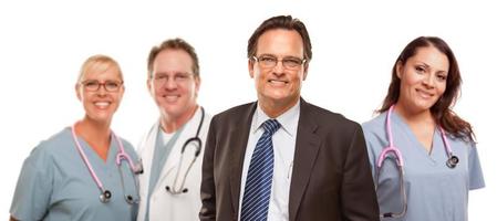 Smiling Businessman with Male and Female Doctors and Nurses photo