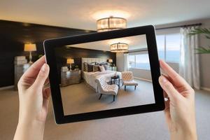 Female Hands Holding Computer Tablet In Room with Photo on Screen.