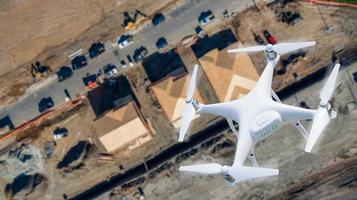 Unmanned Aircraft System UAV Quadcopter Drone In The Air Over Construction Site. photo