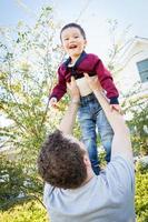 Happy Caucasian Father Having Fun with His Mixed Race Baby Son photo