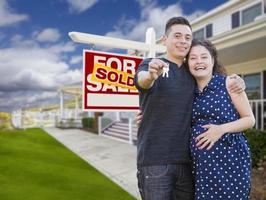 Hispanic Couple with Keys In Front of Home and Sign photo