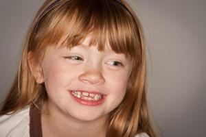 Fun Portrait of an Adorable Red Haired Girl on Grey photo