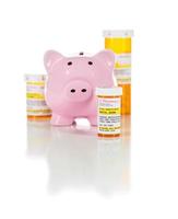 Piggy Bank and Non-Proprietary Medicine Prescription Bottles Isolated on White photo