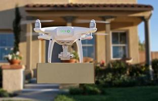 Unmanned Aircraft System UAV Quadcopter Drone Delivering Package To House photo