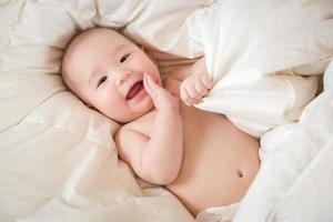 Mixed Race Baby Boy Having Fun on His Blanket photo