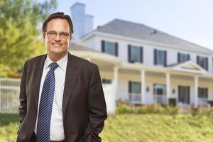 Attractive Businessman In Front of Nice Residential Home photo