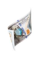 One Hundred Dollar Bill With Medical Face Mask on Benjamin Franklin Isolated on White photo