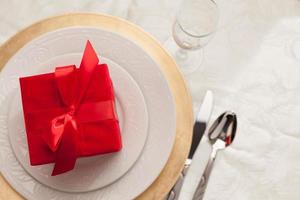 Christmas Gift with Place Setting at Table photo