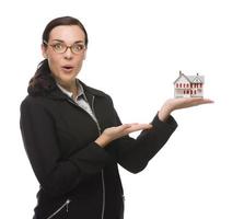 Mixed Race Businesswoman Holding Small House to the Side photo