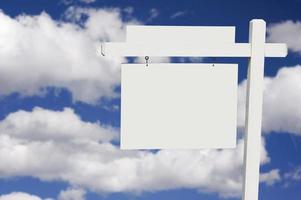 Blank Real Estate Sign on Clouds and Sky Background photo
