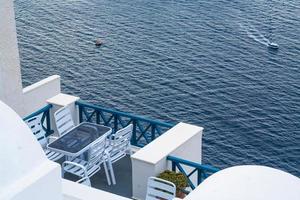 Santorini Greece Home Patio With Ocean View As Cruise Ship Tender Transports Tourists Below photo