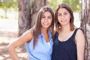 Two Beautiful Ethnic Twin Sisters Portrait Outdoors. photo