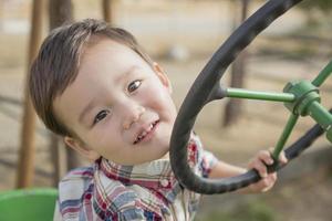 Mixed Race Young Boy Playing on Tractor photo