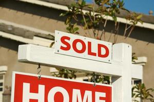 Sold Home For Sale Sign and New House photo