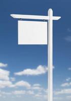 Blank Real Estate Sign Over A Blue Sky with Clouds. photo