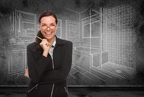 Young Adult Woman with Pencil In Front of Bathroom Design Drawing On Wall photo