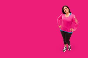 Middle Aged Hispanic Woman In Workout Clothes Against A Bright Pink Background. photo