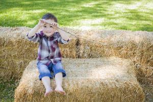 Cute Young Mixed Race Boy Having Fun on Hay Bale photo