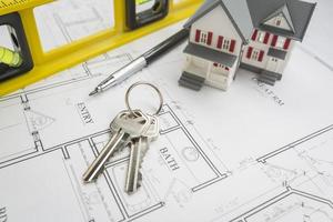 Home, Construction Level, Pencil and Keys Resting on House Plans photo