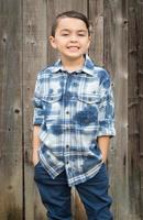 Young Mixed Race Boy Portrait Against Fence photo