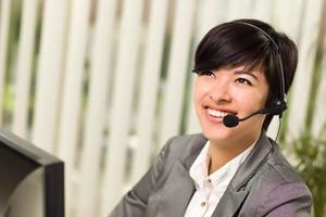 Attractive Young Woman Smiles Wearing Headset photo