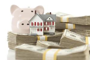 Small House and Piggy Bank with Stacks Money photo