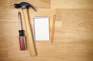 Pad of Paper, Pencil, Hammer and Screwdriver photo