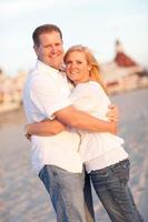 Attractive Caucasian Couple Hugging at the Beach photo
