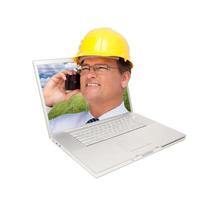 Laptop and Man with Hard Hat on Cell Phone photo