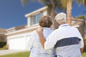 Happy Senior Couple Looking at Front of House photo