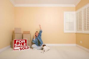 Sold Real Estate Signs, Boxes and Happy Woman on Phone photo