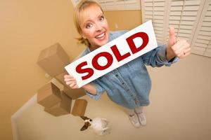 Woman and Doggy with Sold Sign Near Moving Boxes photo