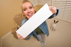 Woman and Doggy with Blank Sign Near Moving Boxes photo