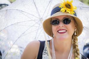 Attractive Woman in Twenties Outfit Holding Parasol photo