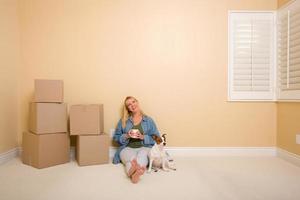 Relaxing Woman and Dog Next to Boxes on Floor photo