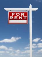 Left Facing For Rent Real Estate Sign on a Blue Sky with Clouds. photo