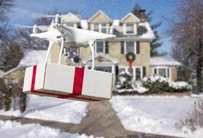Unmanned Aircraft System UAV Quadcopter Drone Delivering Box With Red Ribbon To Home photo
