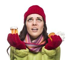 Sick Mixed Race Woman with Empty Medicine Bottles and Tissue photo